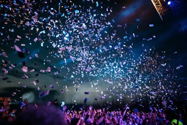 Confetti in the night sky over an open air concert crowd